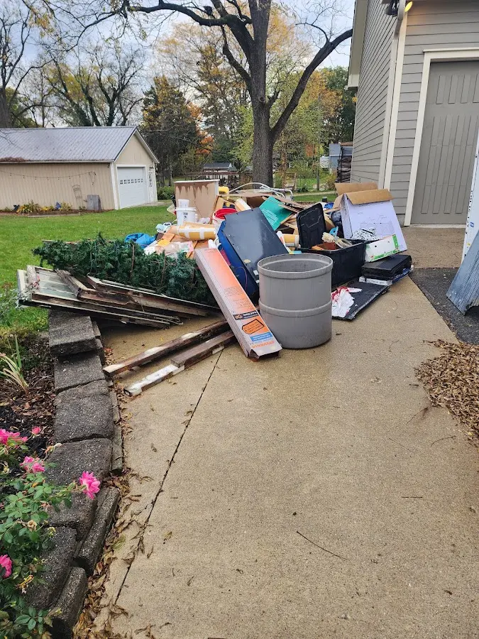 Dumpster being loaded with debris for 10 Yard Dumpster Rental in Swampscott